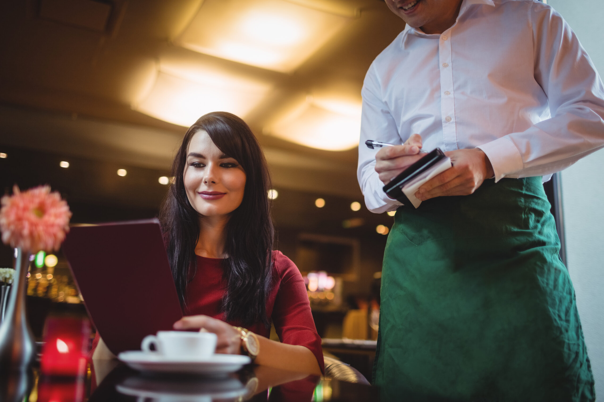 Waiter taking order from woman in a restaurant